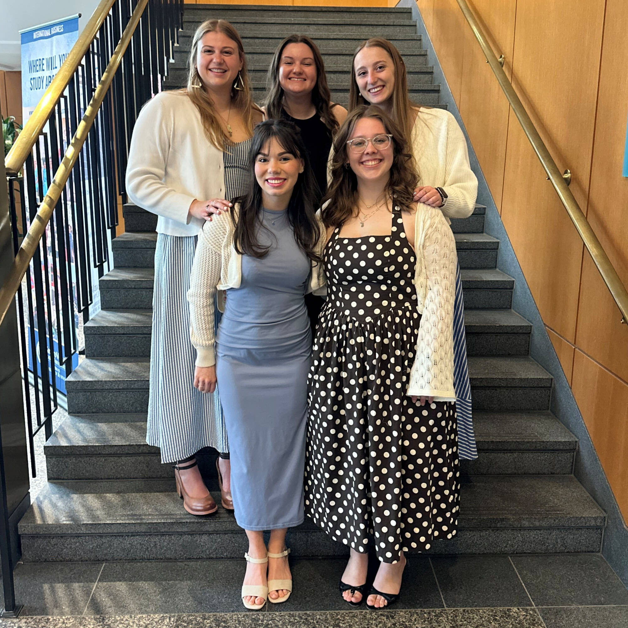 Five students standing on stairs